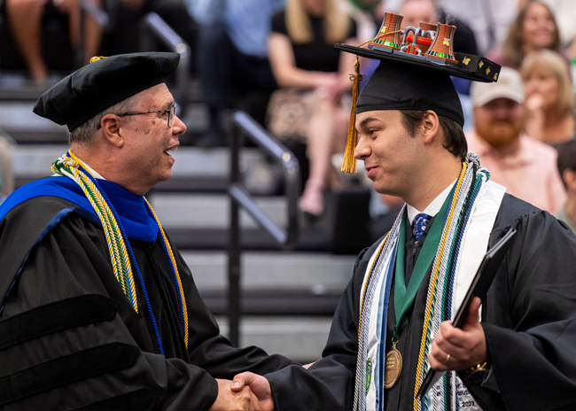 Graduating Student shaking hands with professor